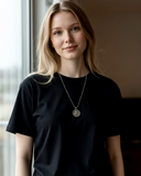 girl wearing silver lamb coin necklace